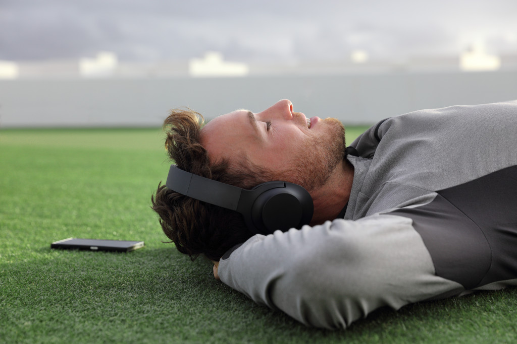 Man wearing headphones while lying down