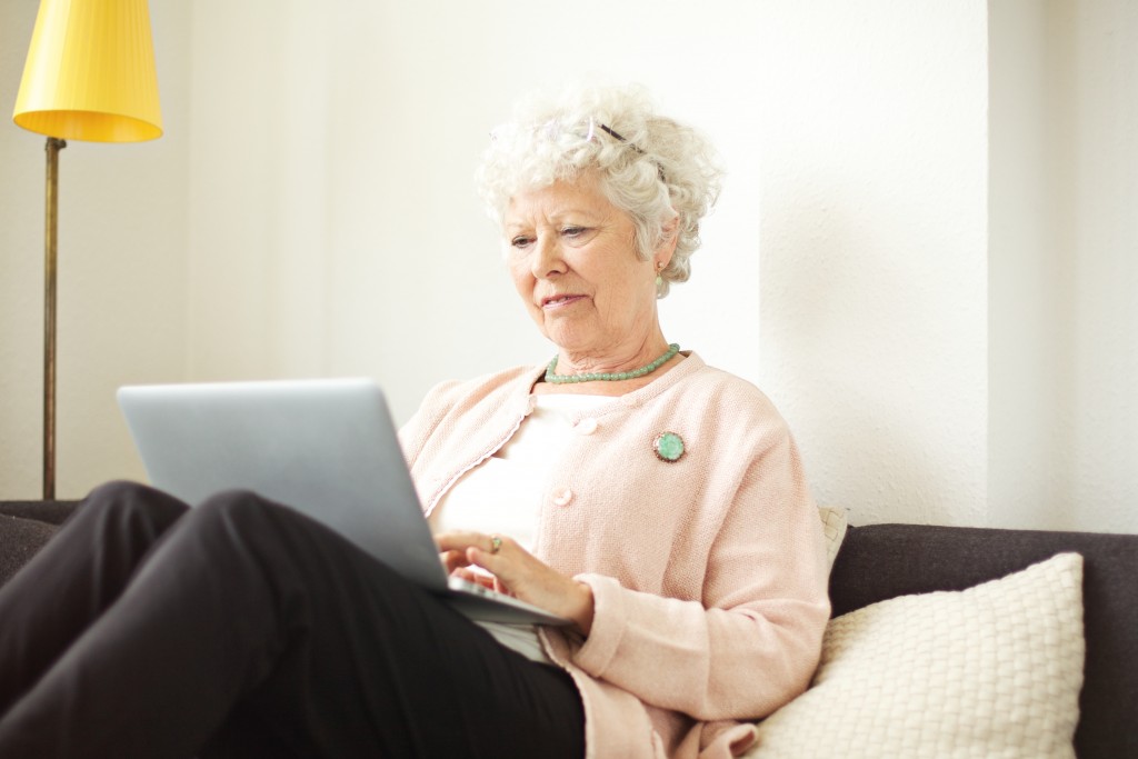 grandmother using a laptop at home