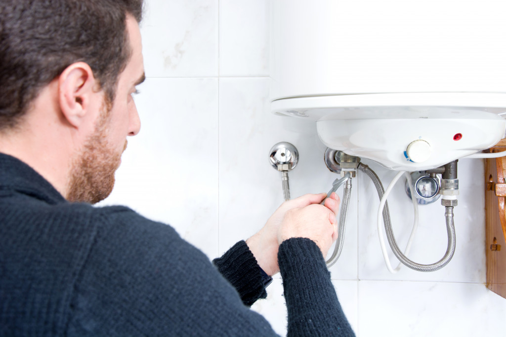 Plumber checking the plumbing of a sink.