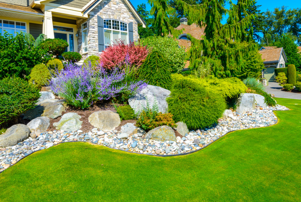 Well-maintained front lawn of a house with flowers and plants.